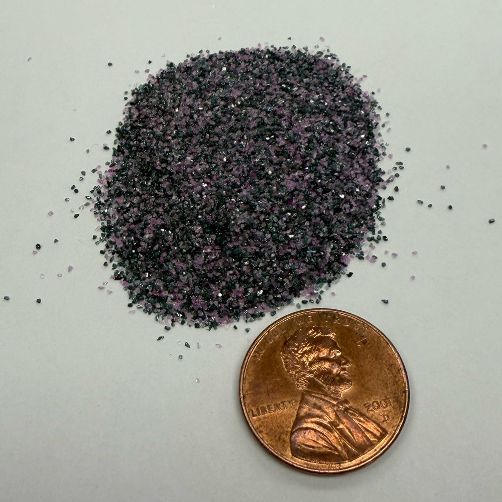 Small pile of D-DC 600 Hi-Mid Hone media shone with a penny for size comparison