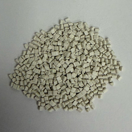 Close up of a small pile of precision ceramic media, triangular shaped (part# C-TRI 2x2mm A3 shown)