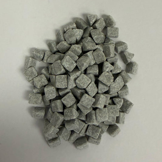 Close up of a small pile of precision ceramic media part # C-TRI 4x4mm C